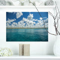 DESIGN ART Designart "White Fluffy Clouds Over Sea" Oversized Beach Canvas Artwork 20 in. wide x 12 in. high