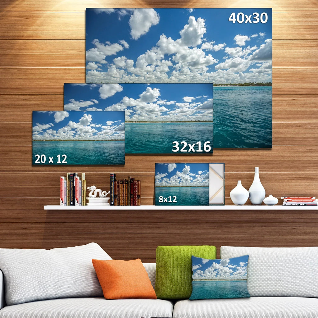 DESIGN ART Designart "White Fluffy Clouds Over Sea" Oversized Beach Canvas Artwork 20 in. wide x 12 in. high